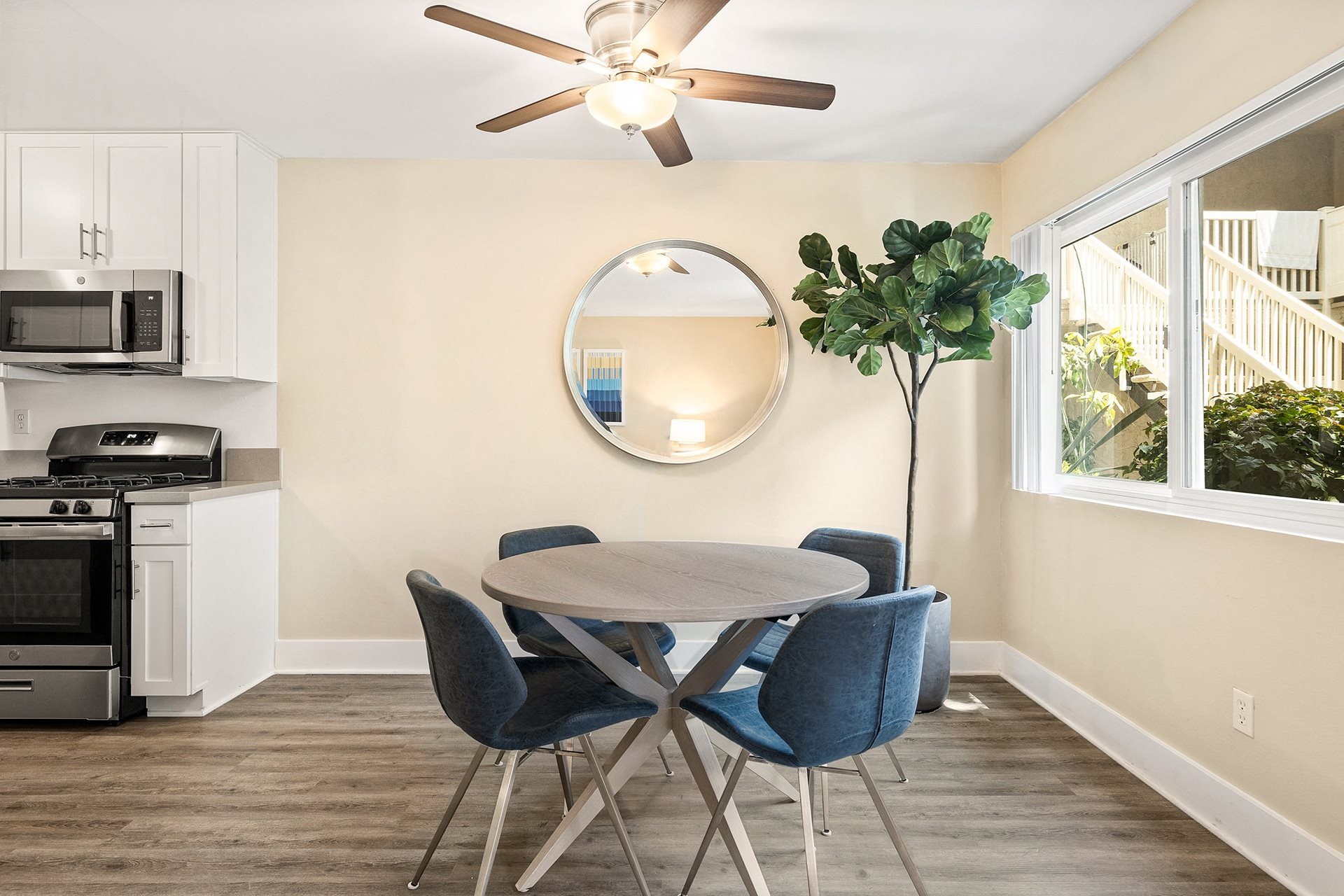 a dining area with a table and four chairs and a ceiling fan at Casa De Marina Apartments, Los Angeles, CA 90066